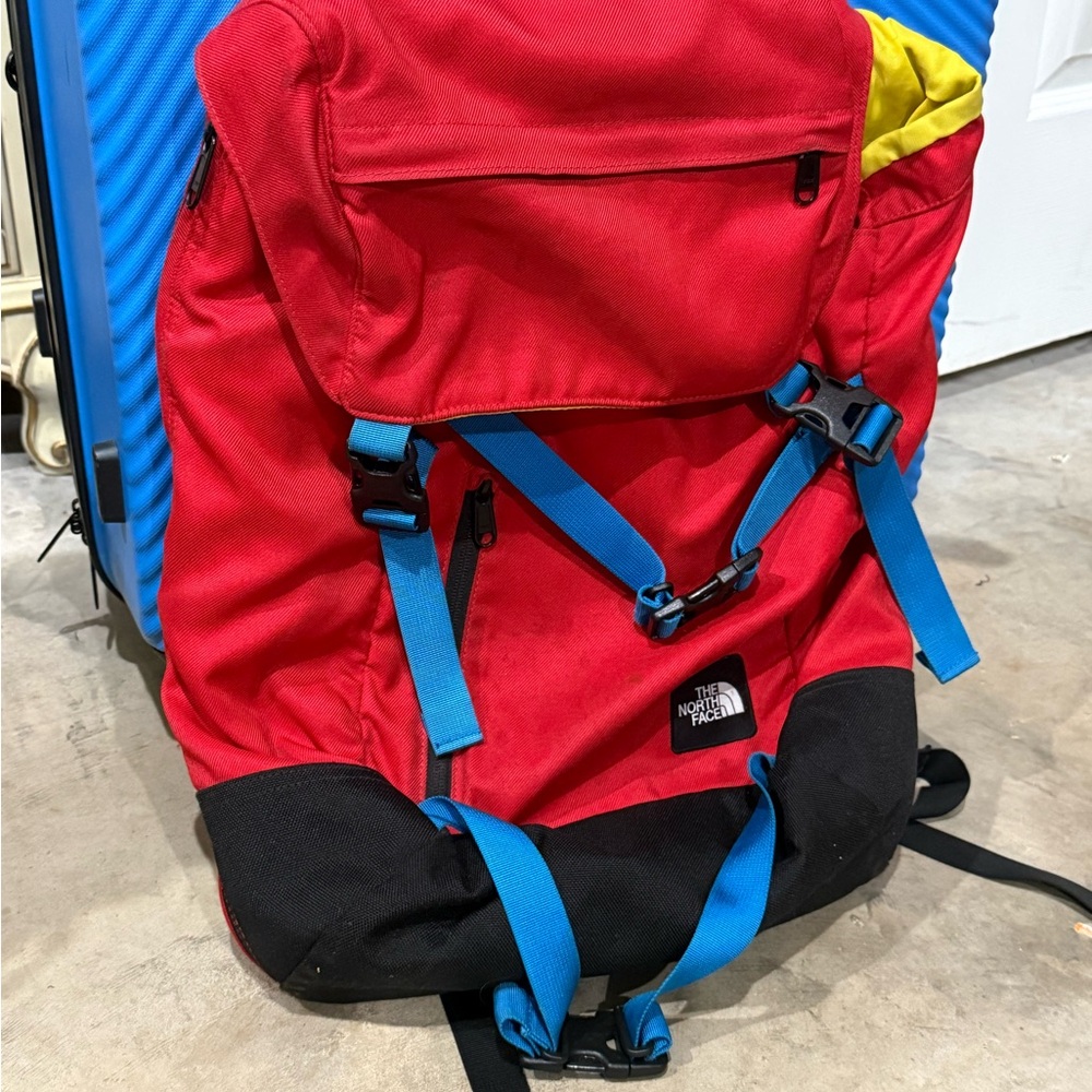 The North Face Red Backpack with Blue and Yellow Accents